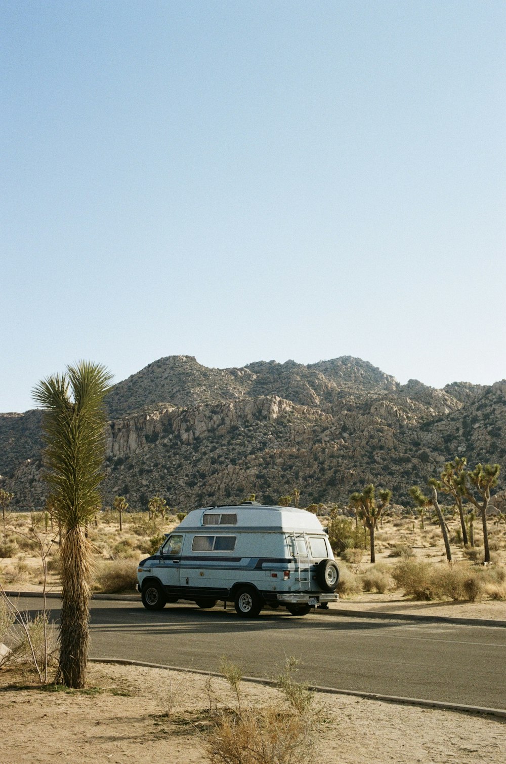 a van is parked on the side of the road