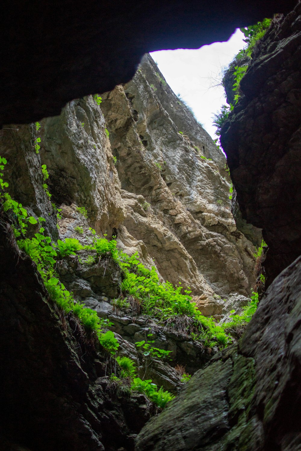 a view of a rocky mountain with a small opening in the middle