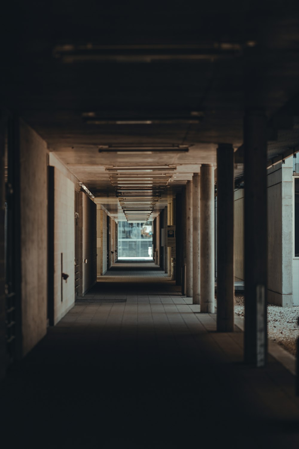 a long hallway in a building with a clock on the wall