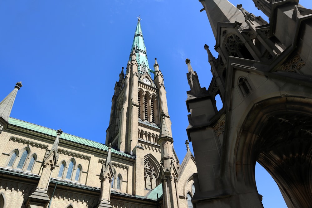 a large cathedral with a steeple and a blue sky