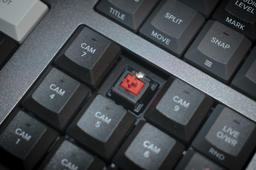 a close up of a keyboard with a red light on it