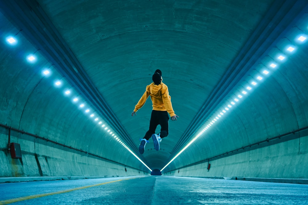 a person jumping in the air in a tunnel