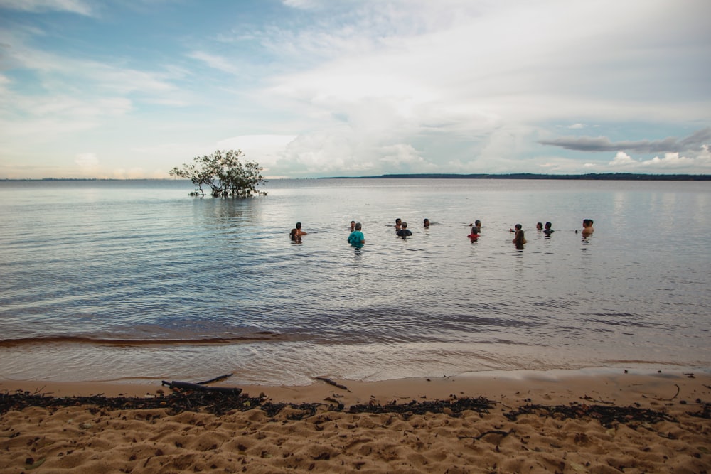 a group of people are wading in the water