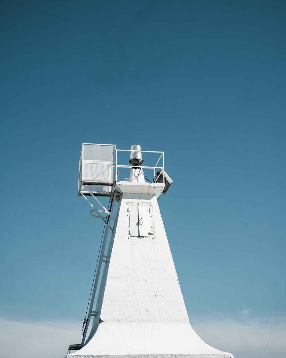 a tall white tower with a sky background