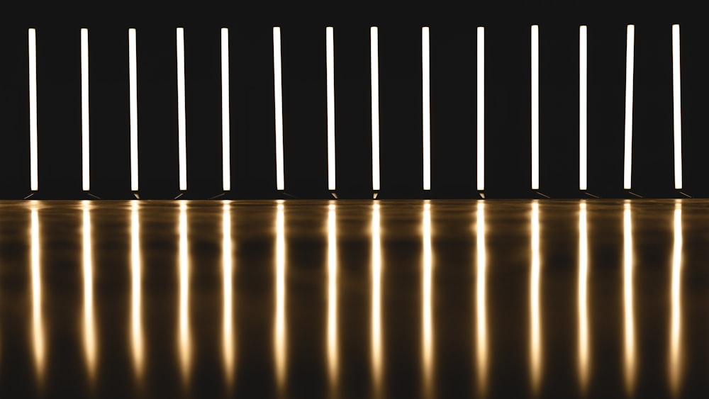 a row of white lights in a dark room