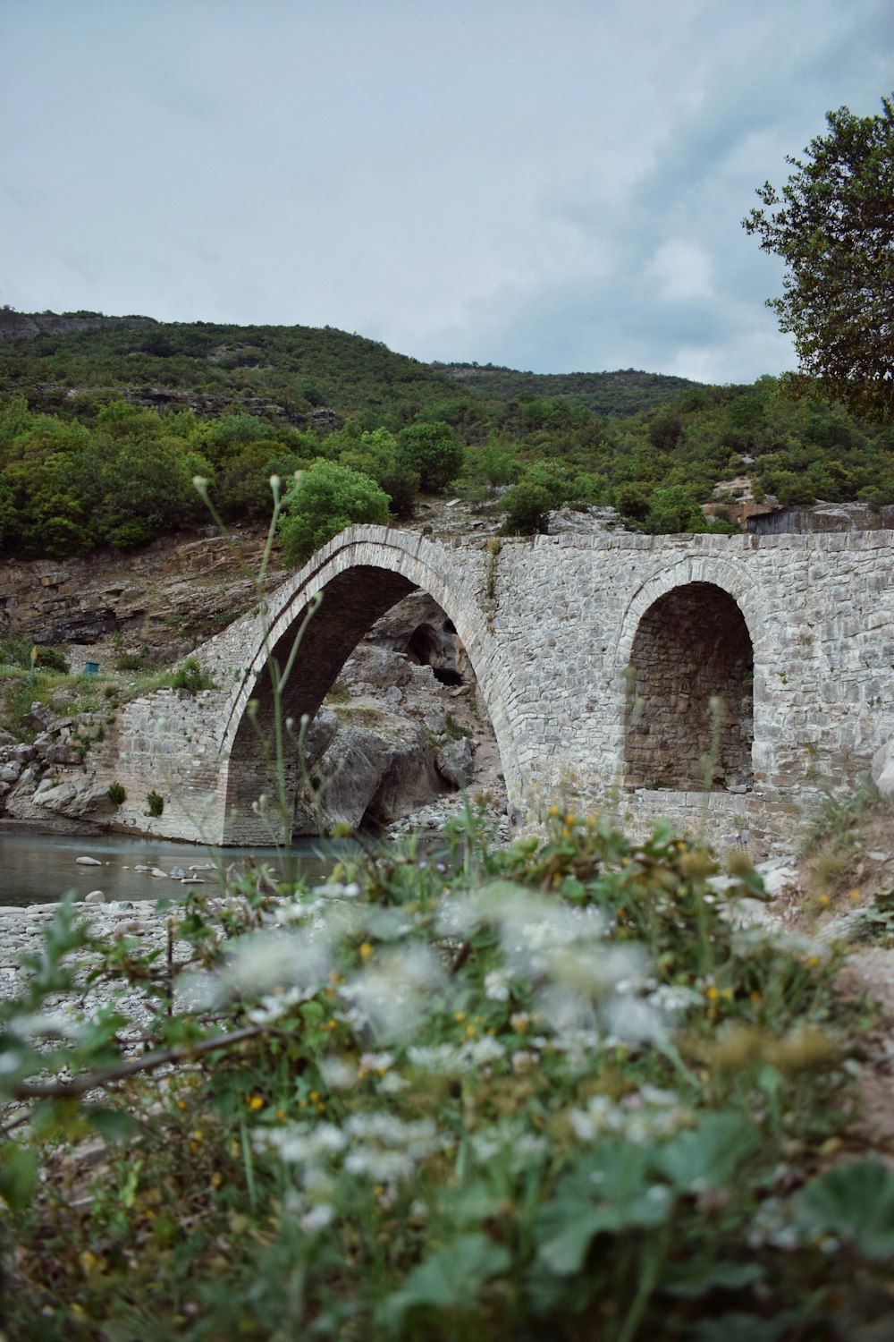 a stone bridge over a small river