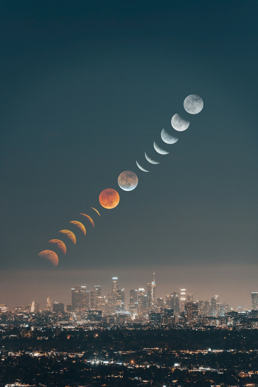 a group of phases of the moon over a city