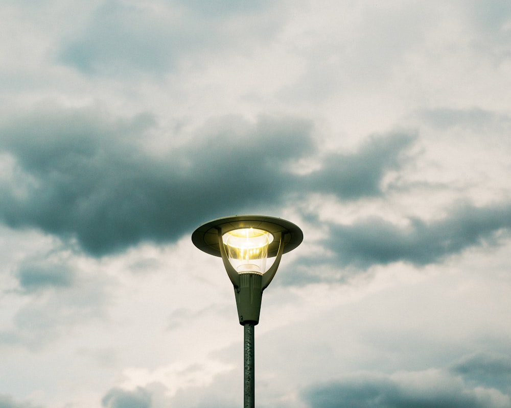 a street light with a cloudy sky in the background