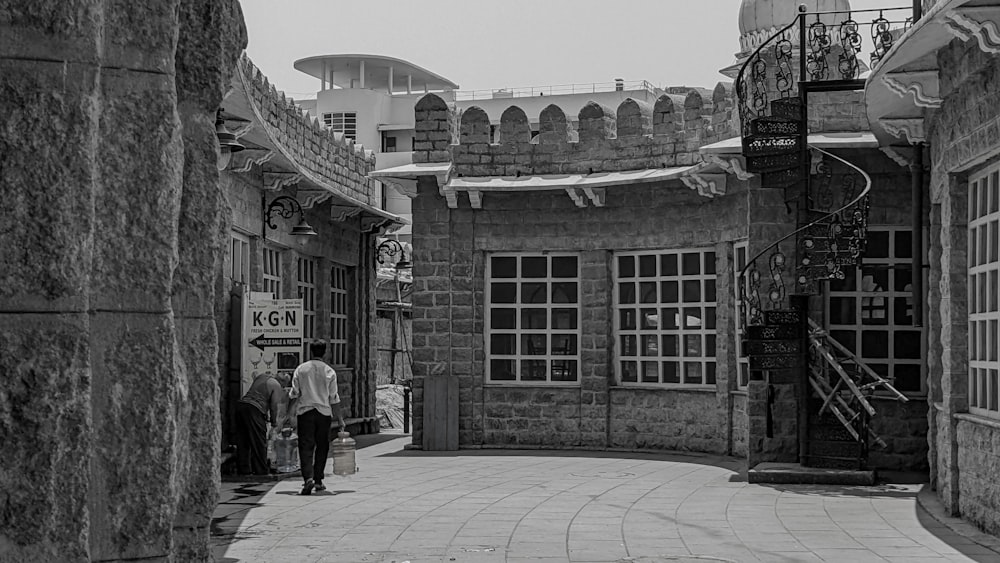 a couple of people walking down a street