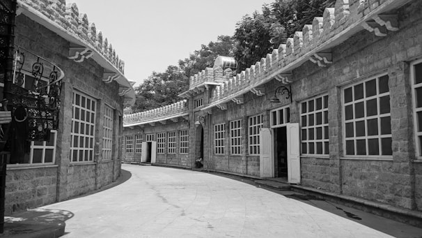Vintage photograph of university buildings with students walking nearby.