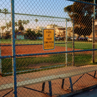 a baseball field behind a chain link fence