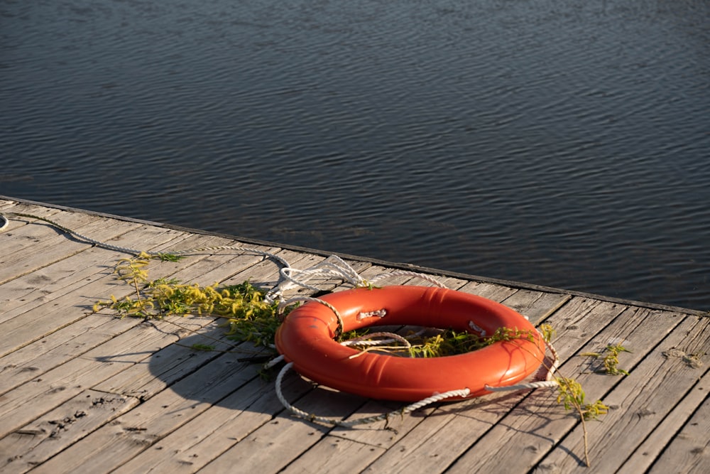 a life preserver on a dock next to a body of water