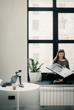 a woman sitting on a couch reading a book
