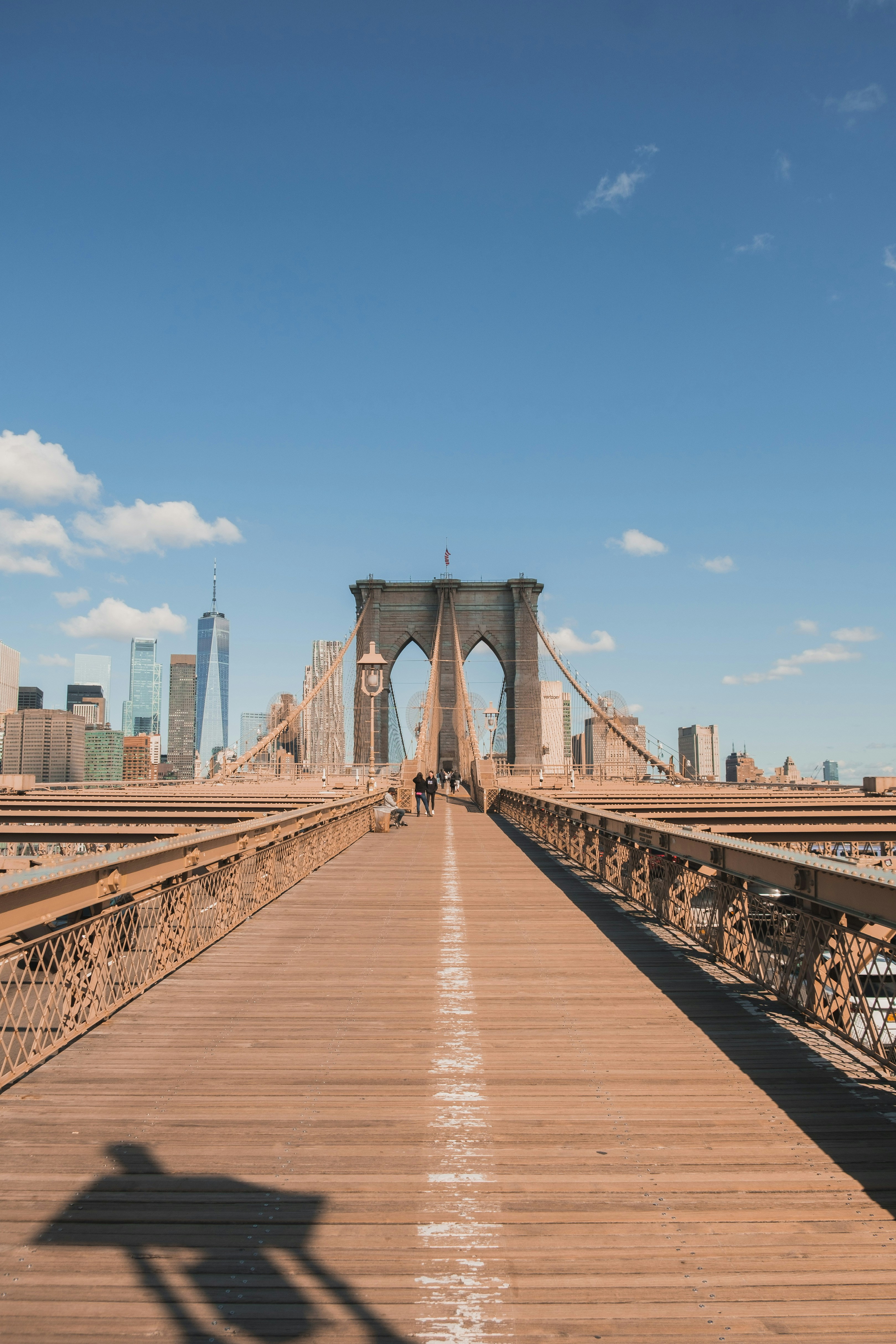 a shadow of a person standing on a bridge