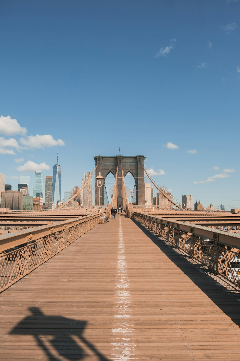 a shadow of a person standing on a bridge