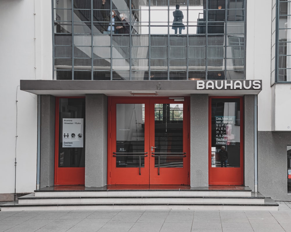 the entrance to a building with red doors
