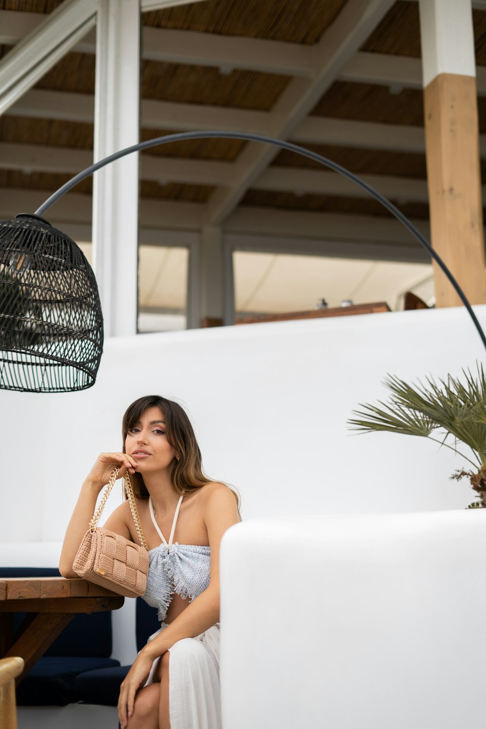 a woman in a white dress sitting at a table