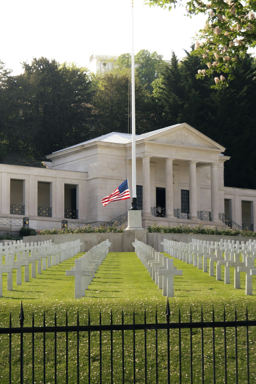 the american flag is flying over a cemetery