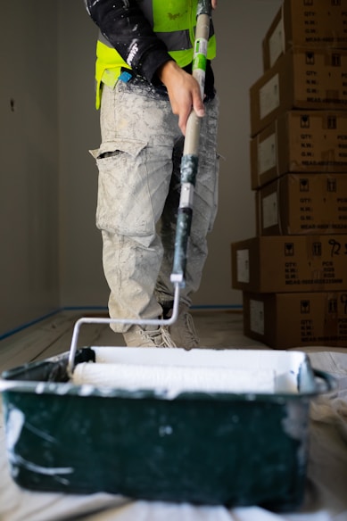 a man with a paint roller painting a wall