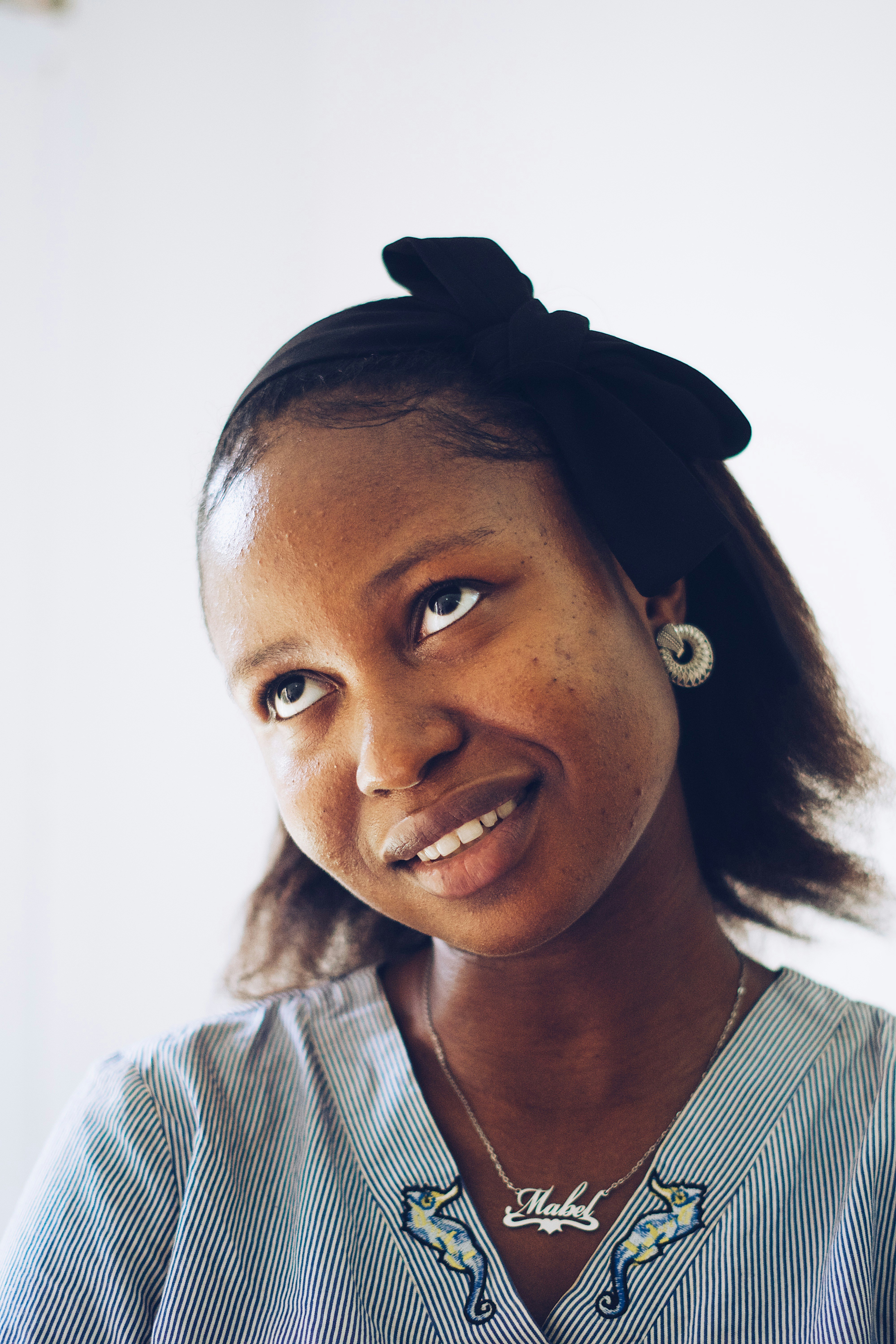a woman with a black bow in her hair