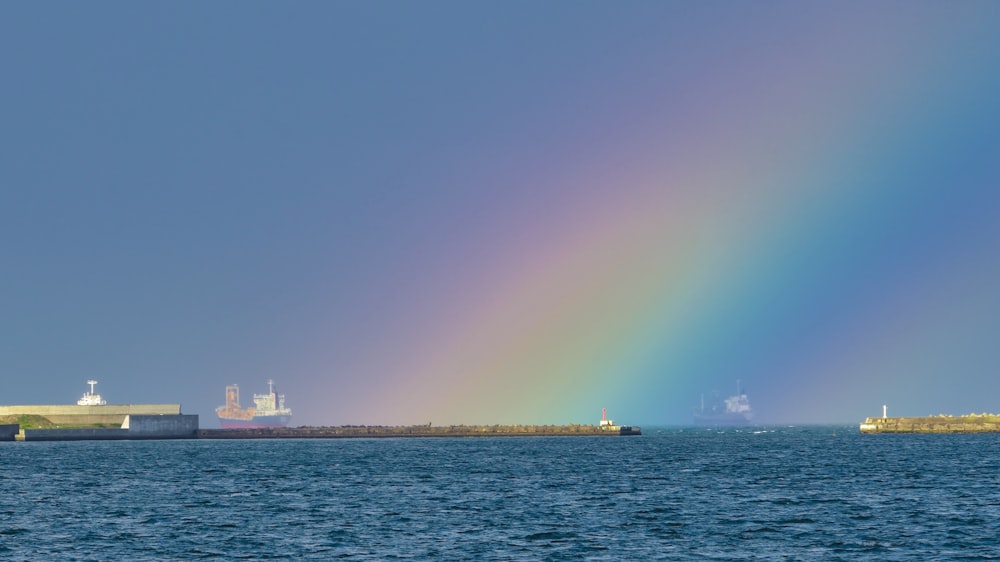 a rainbow in the sky over a large body of water