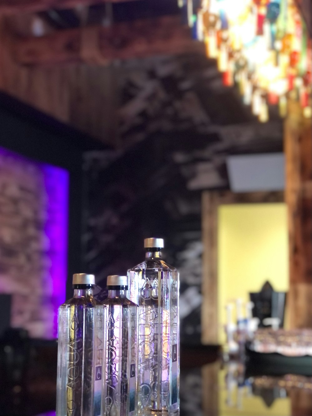 three bottles of liquor sitting on a table