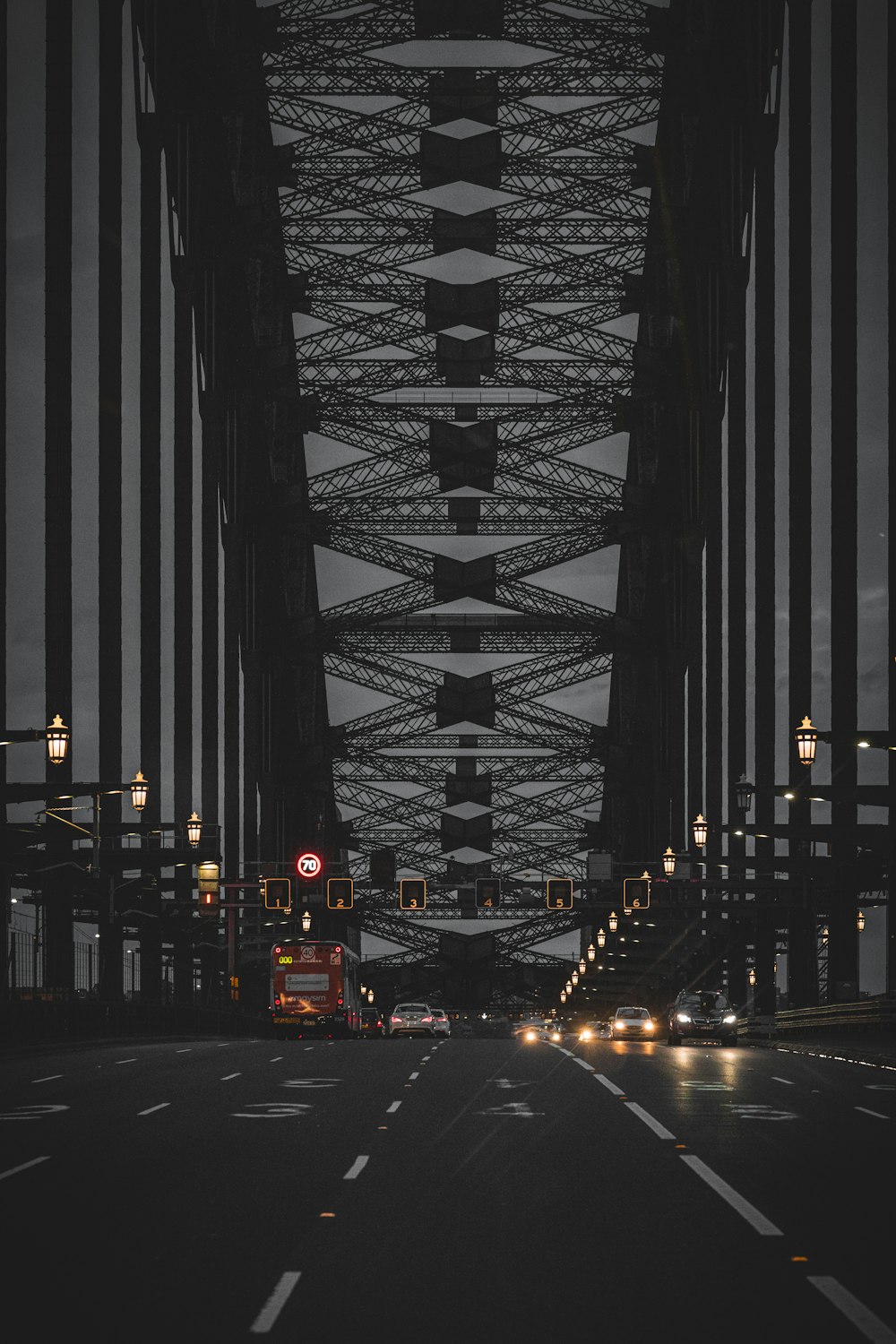 a bus driving across a bridge at night