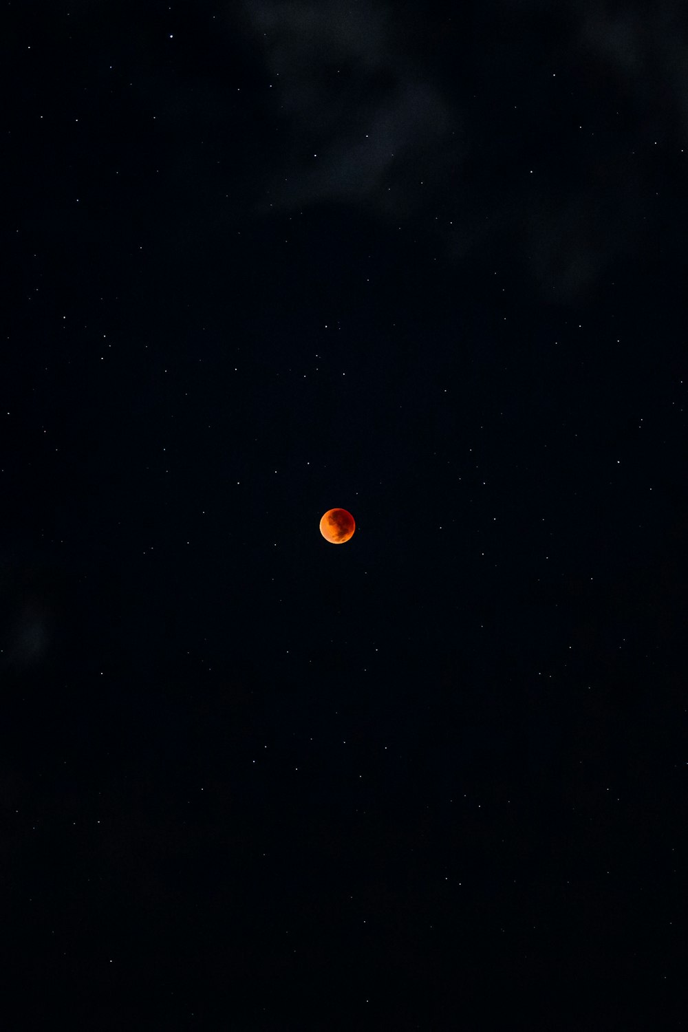 Une lune rouge est vue dans le ciel nocturne