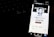 A smartphone screen displays a profile page with a black and white profile picture of a person. The screen indicates the status 'Founder' and shows social media icons and options like 'Remove Featured.' It is positioned in front of a dark keyboard, with illuminated keys slightly visible in the background.