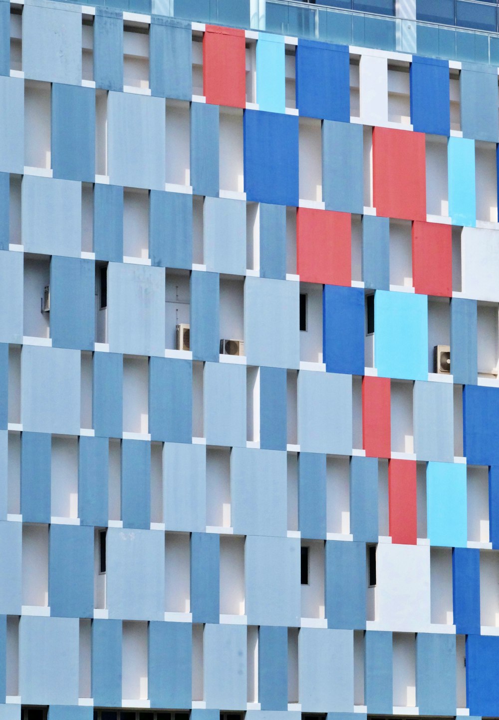 a multicolored building with a clock on the front of it