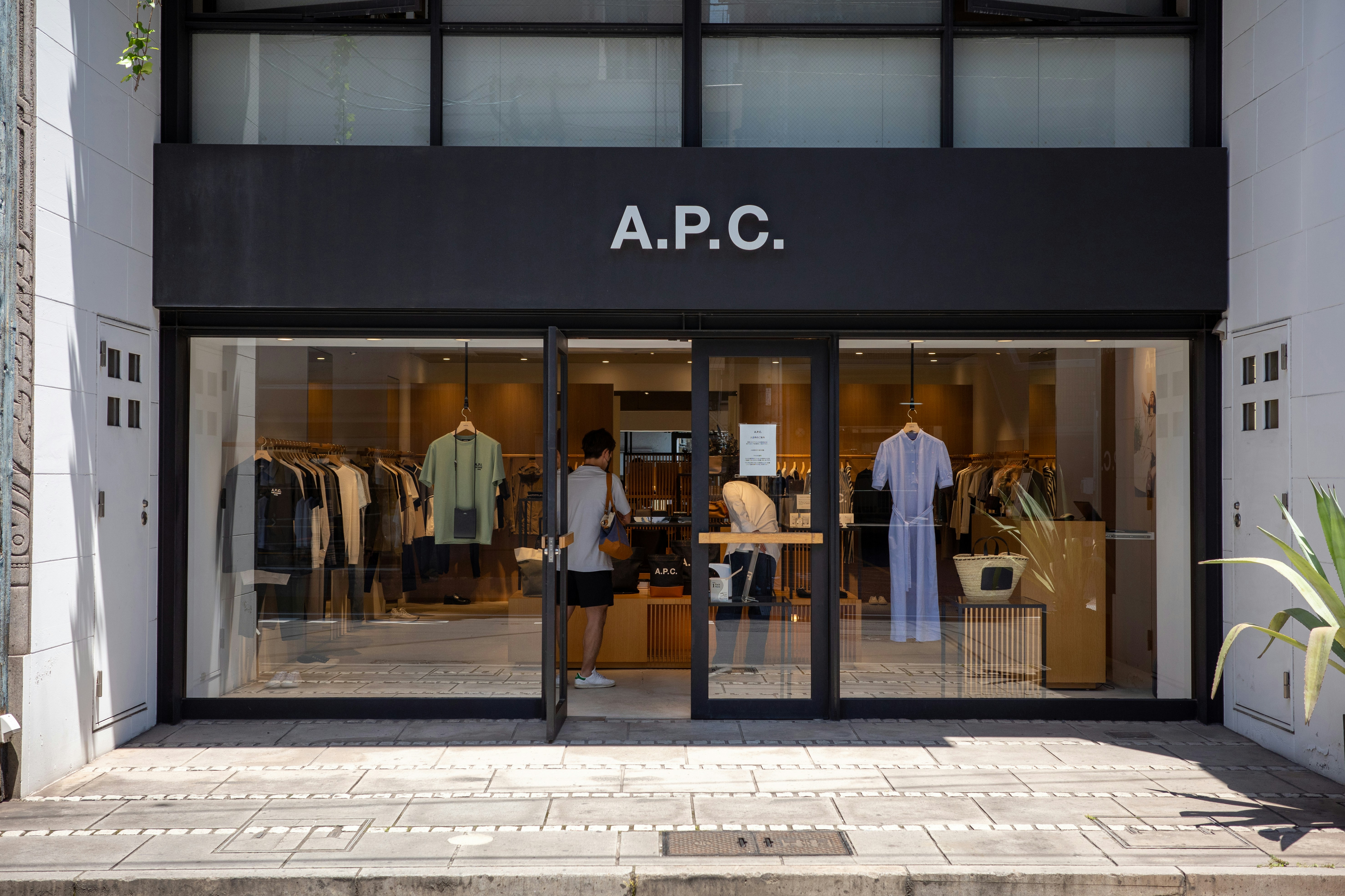 a store front with a man standing in front of it