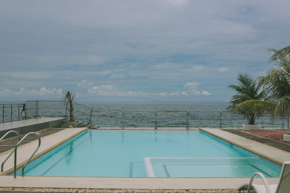 an empty swimming pool with a view of the ocean
