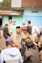A diverse group of people wearing casual trendy clothes and caps outdoors.