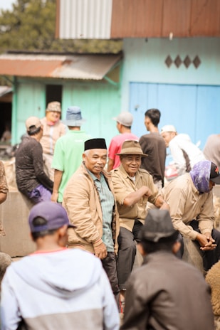 A diverse group of people wearing casual trendy clothes and caps outdoors.
