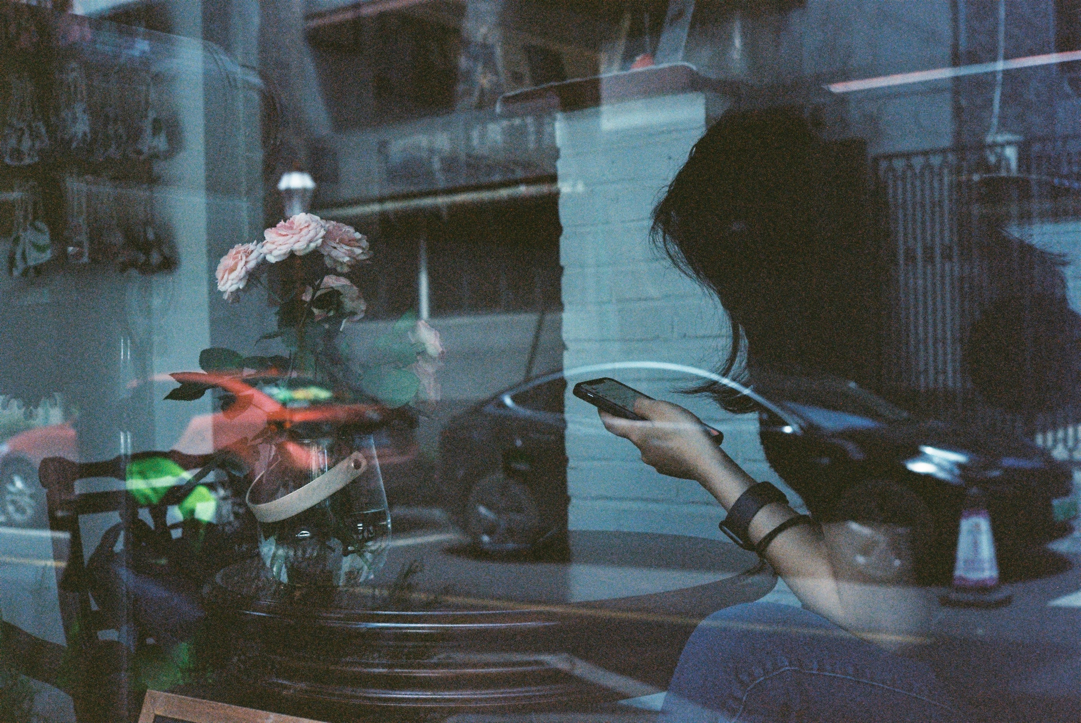 a woman sitting on a bench looking at her cell phone