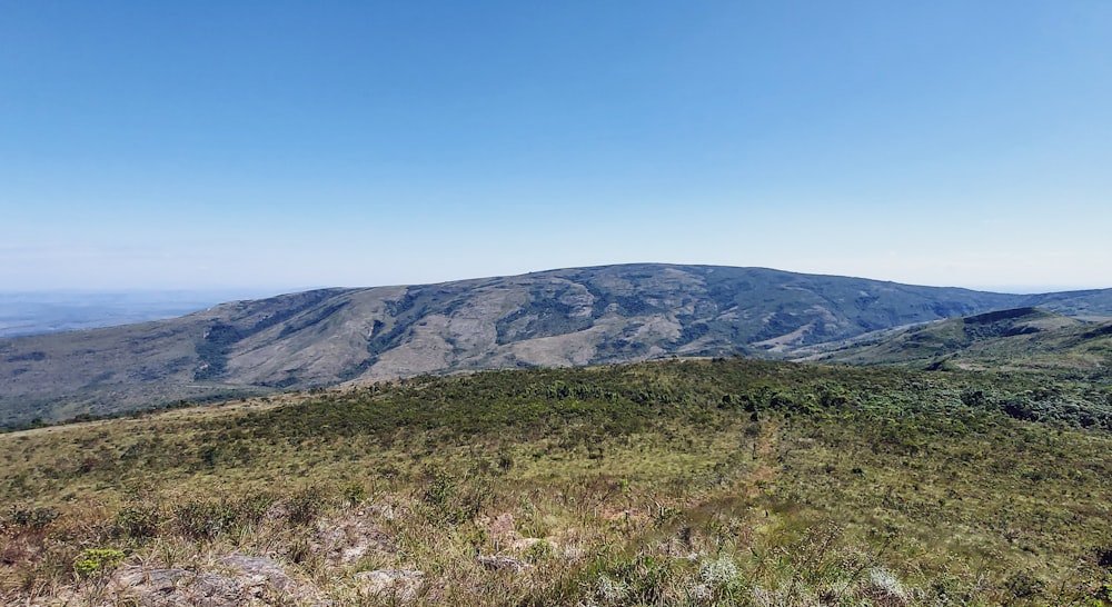 a view of a mountain range from the top of a hill