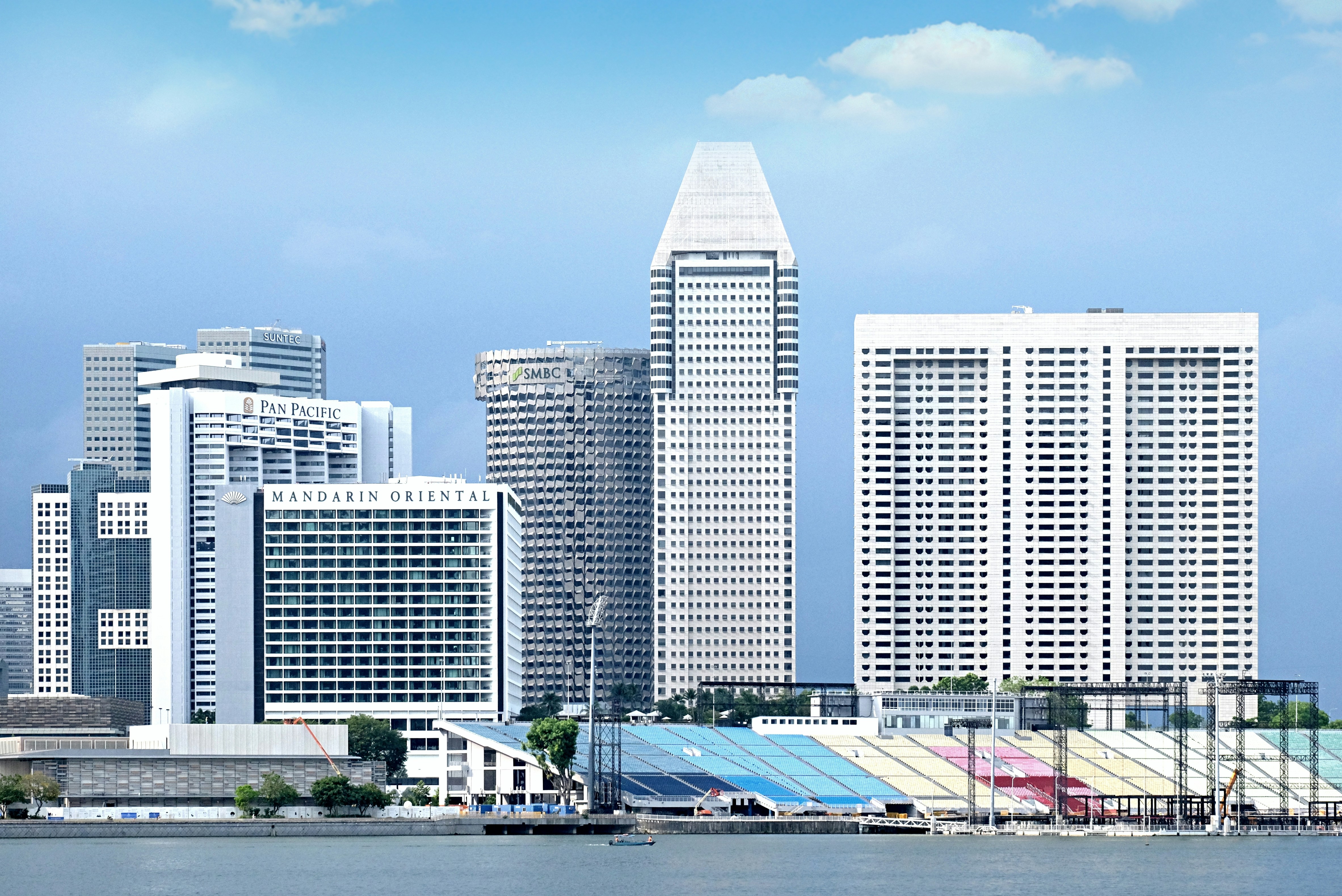 a city with a lot of tall buildings next to a body of water