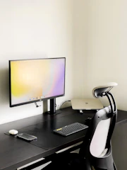 A minimalist workspace featuring a comfortable ergonomic chair.