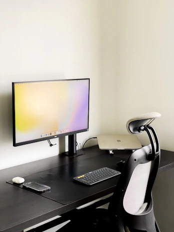 Elegant workspace with minimalist design featuring black, graphite gray, and bronze accents.