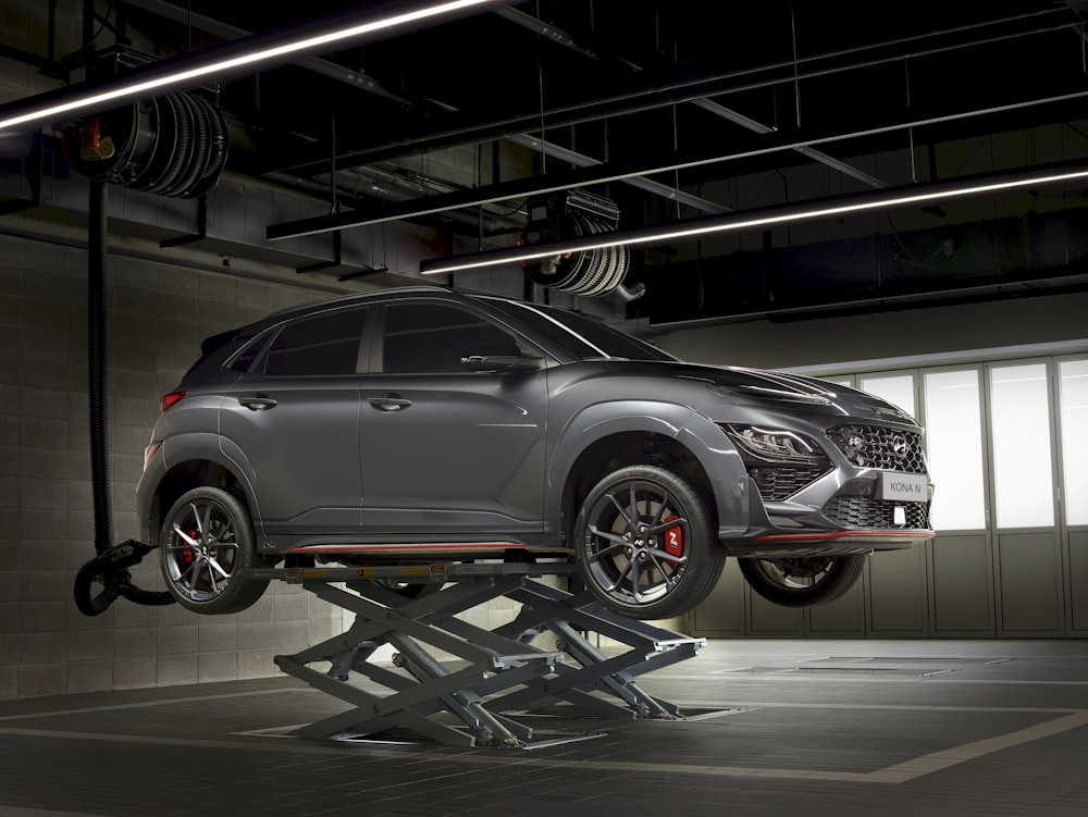 a car on a lift in a garage