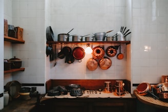 a kitchen with pots and pans hanging on the wall