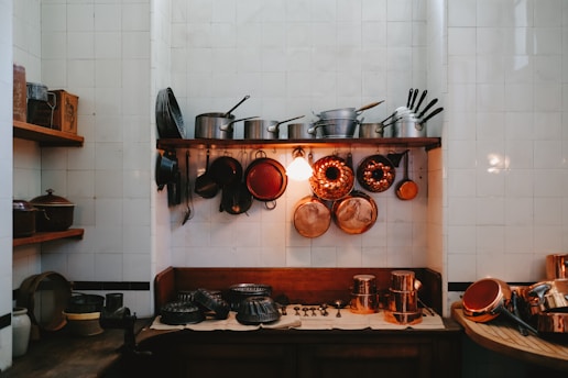 a kitchen with pots and pans hanging on the wall