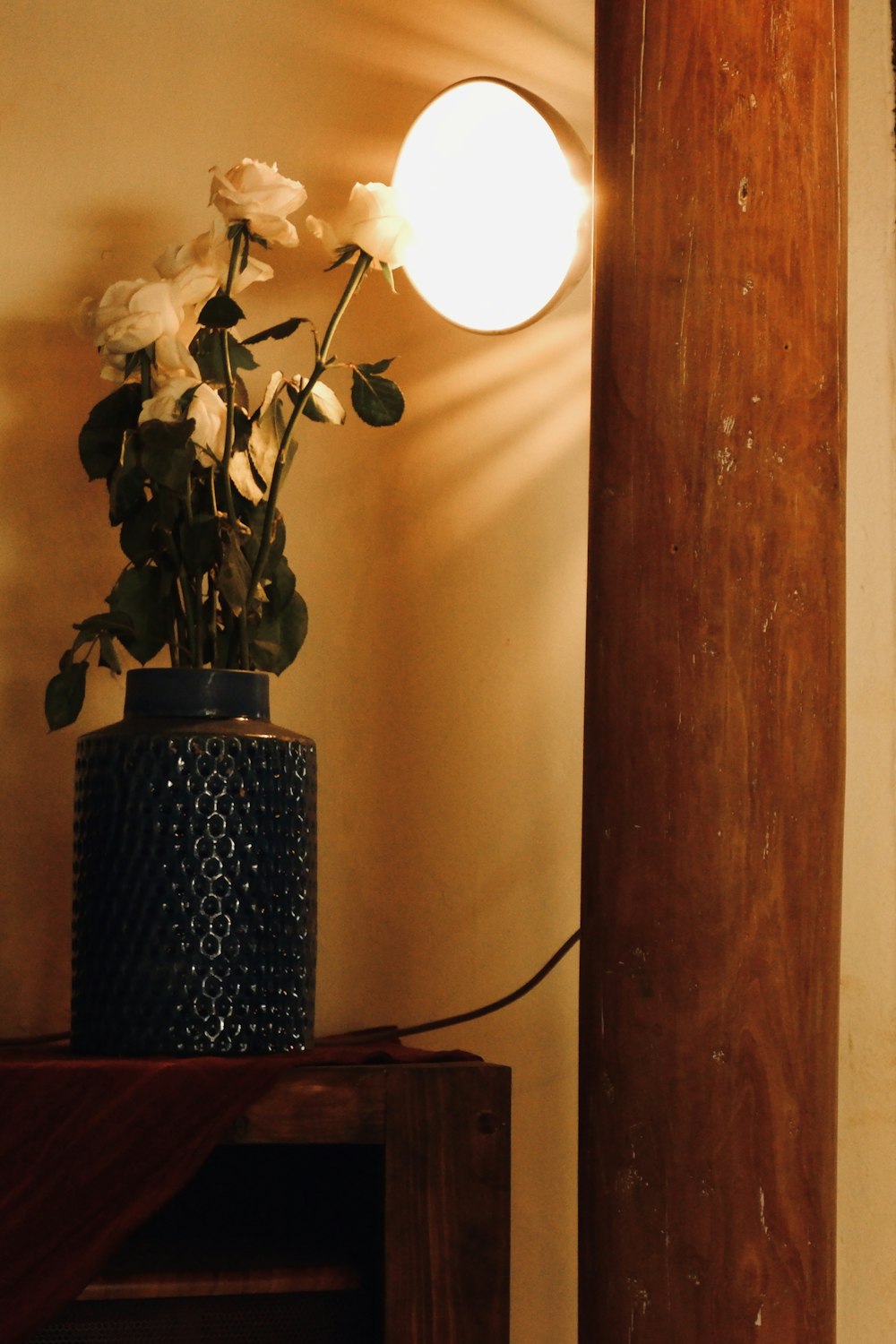 a vase with white flowers sitting on a table