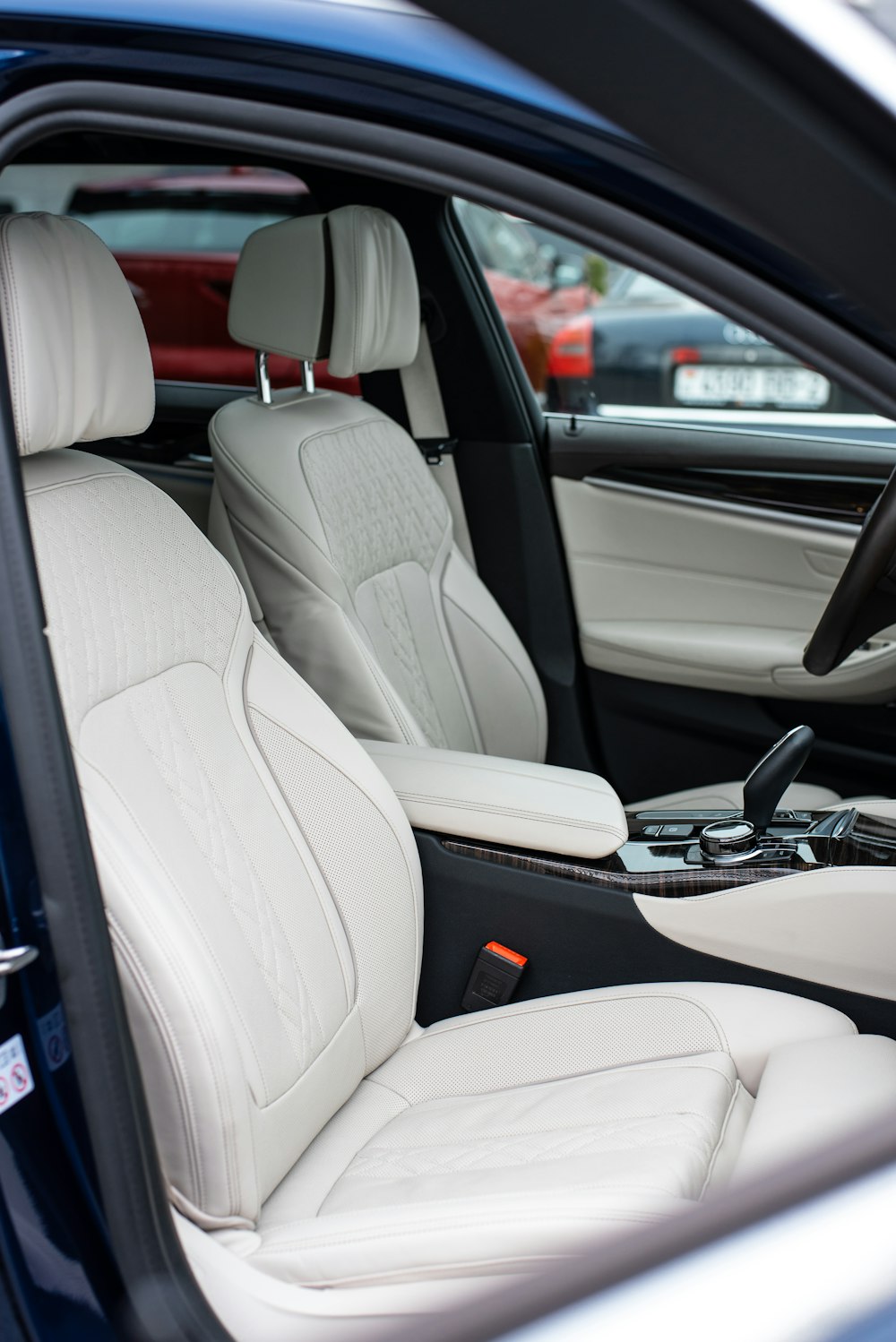 the interior of a car with white leather seats