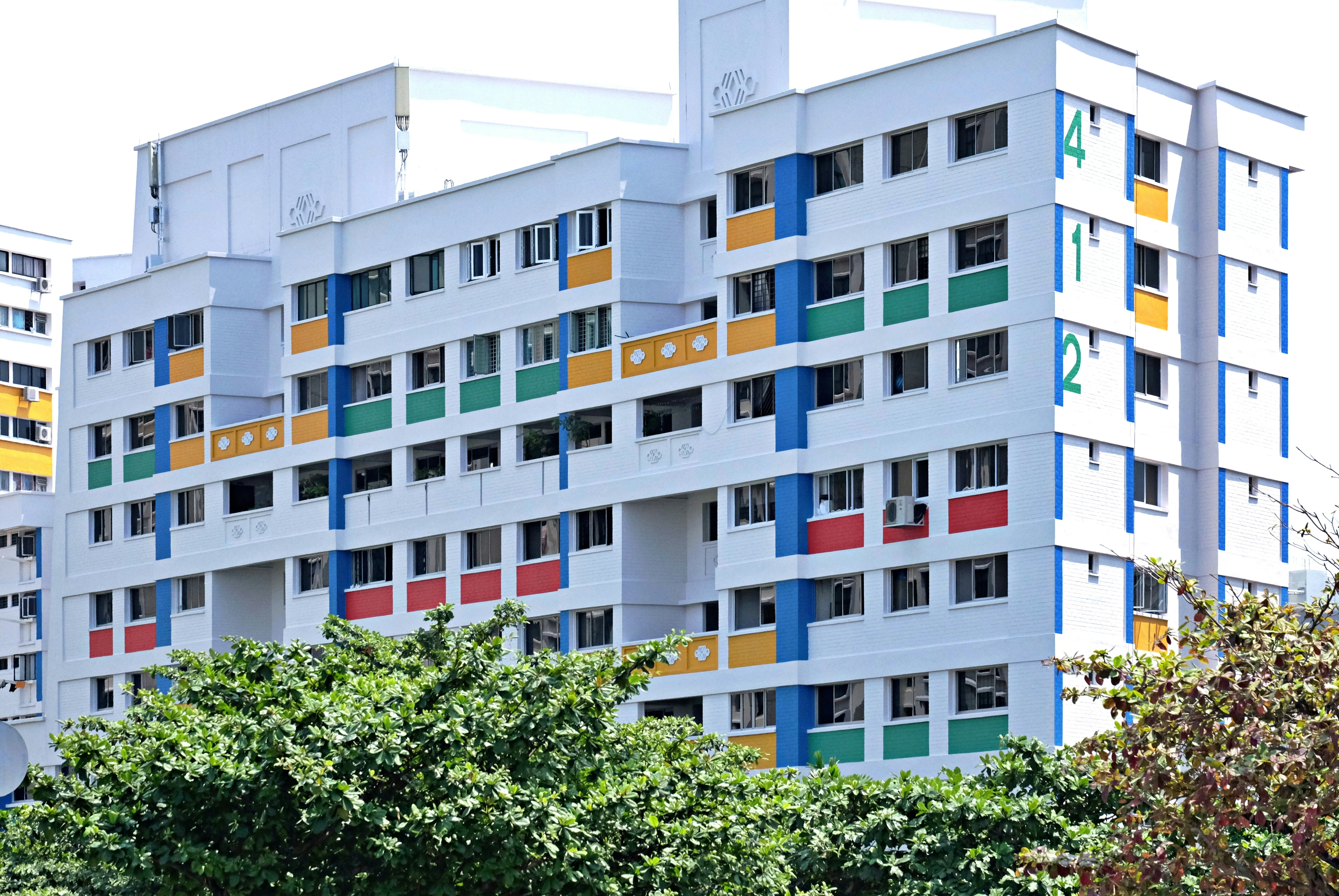 a multicolored building with trees in front of it