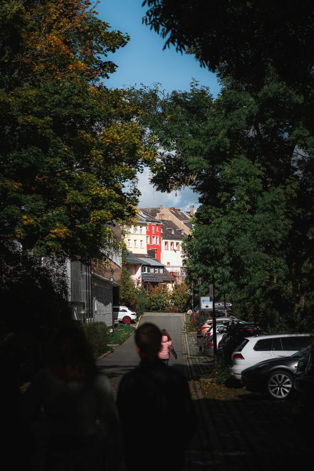 a couple of people walking down a street