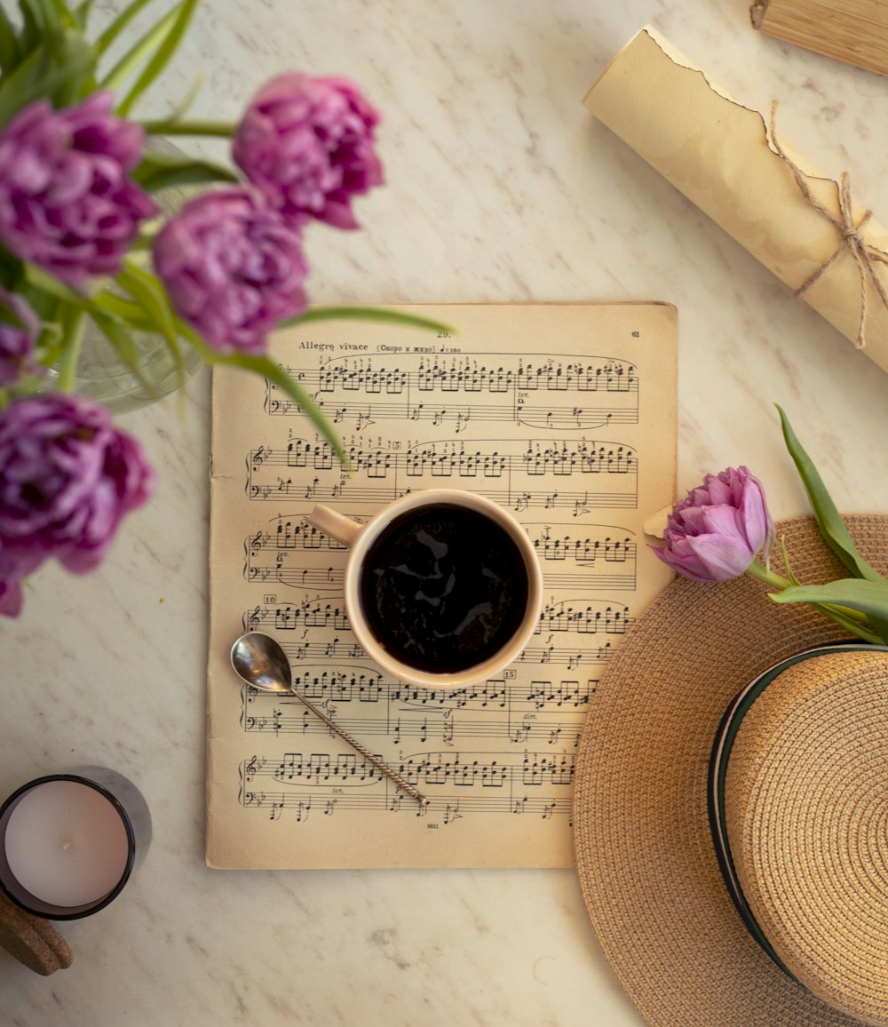 a cup of coffee sitting on top of a book