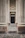A serene garden entrance framed by elegant Greco-Roman concrete columns.
