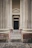 A serene garden entrance framed by elegant Greco-Roman concrete columns.