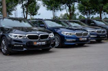 A row of polished sedans lined up outside the velocea dealership.